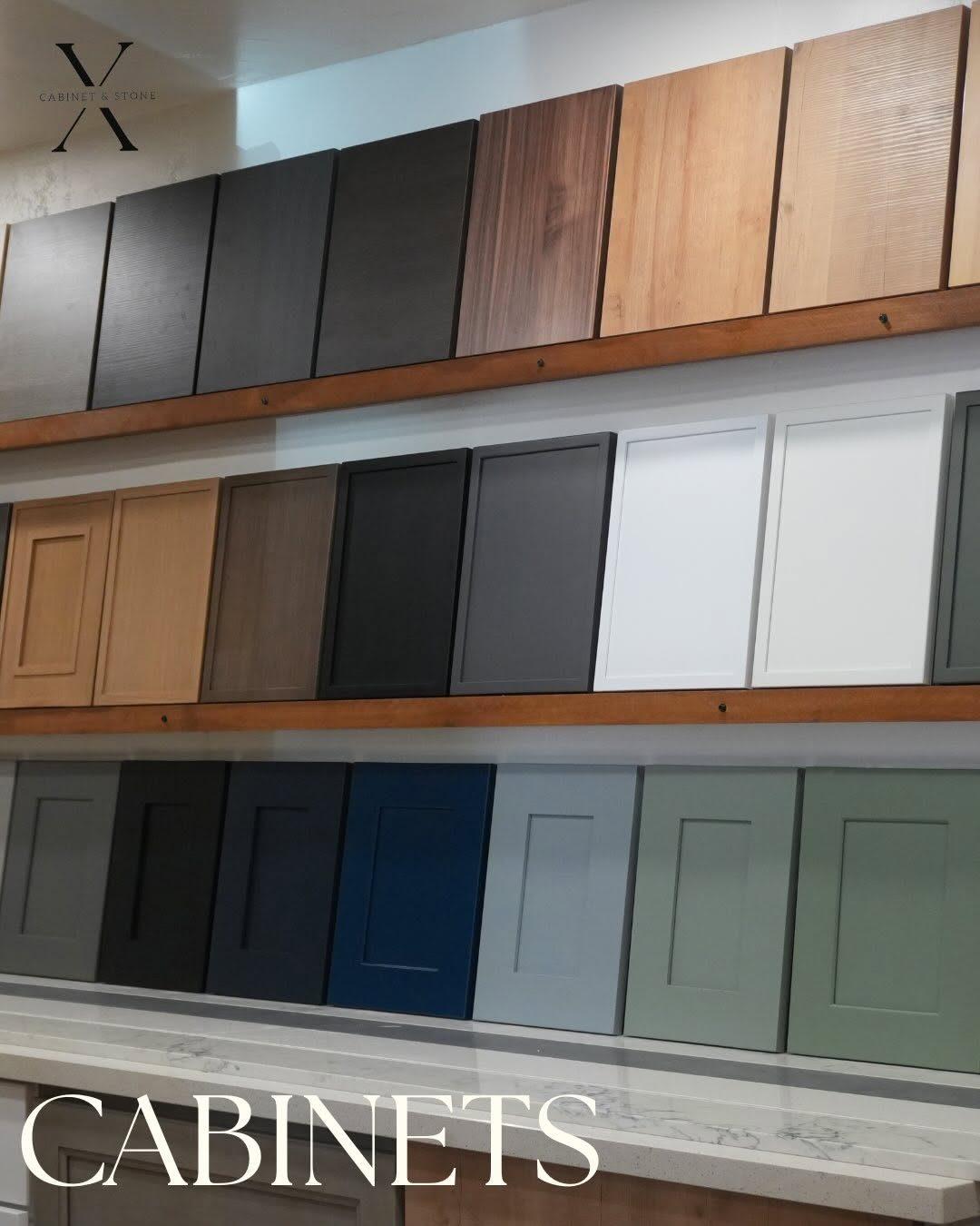 Wall of cabinet door samples in wood, white, navy and green finishes, X Cabinet & Stone, Flagstaff, AZ