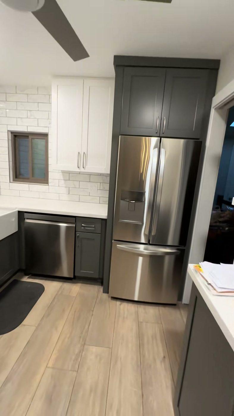 Kitchen remodel in Flagstaff, AZ — white upper cabinets, dark lower cabinets and quartz countertops