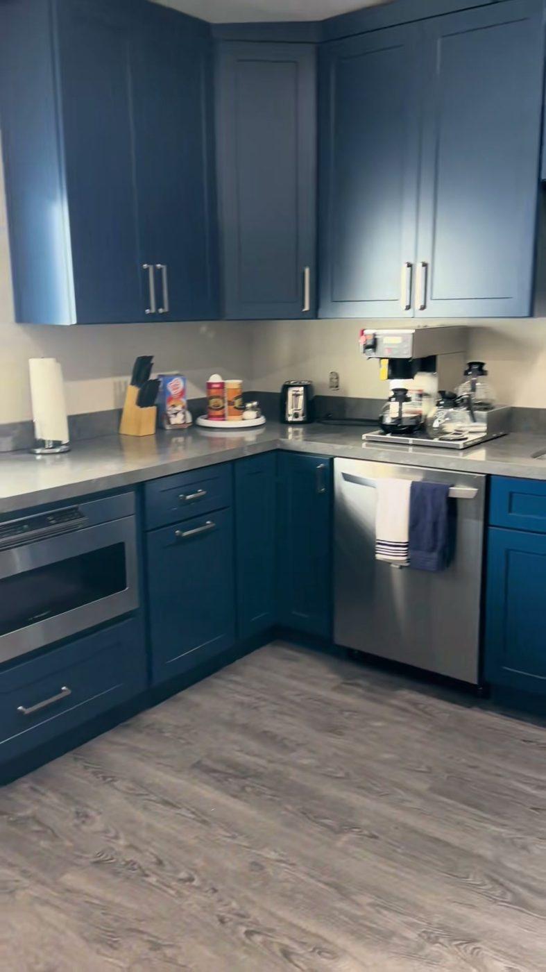 Navy blue kitchen cabinets with stainless appliances and vinyl plank flooring, Flagstaff, AZ